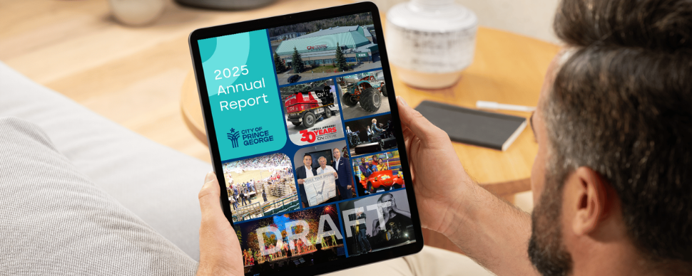 A man holding a tablet with the 2025 Annual Report draft on screen